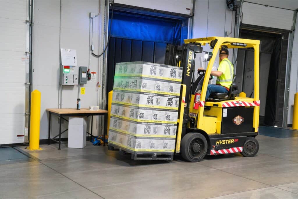 Forklift moving a palette of Joe IPA